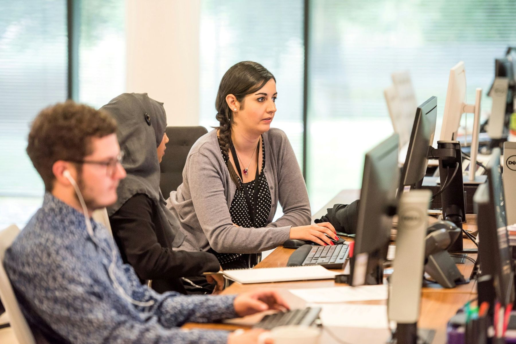 Three people working at the office